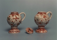 A pair of mustard pots of coloured Arita porcelain